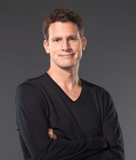 Daniel Tosh in a black t-shirt poses for a picture.